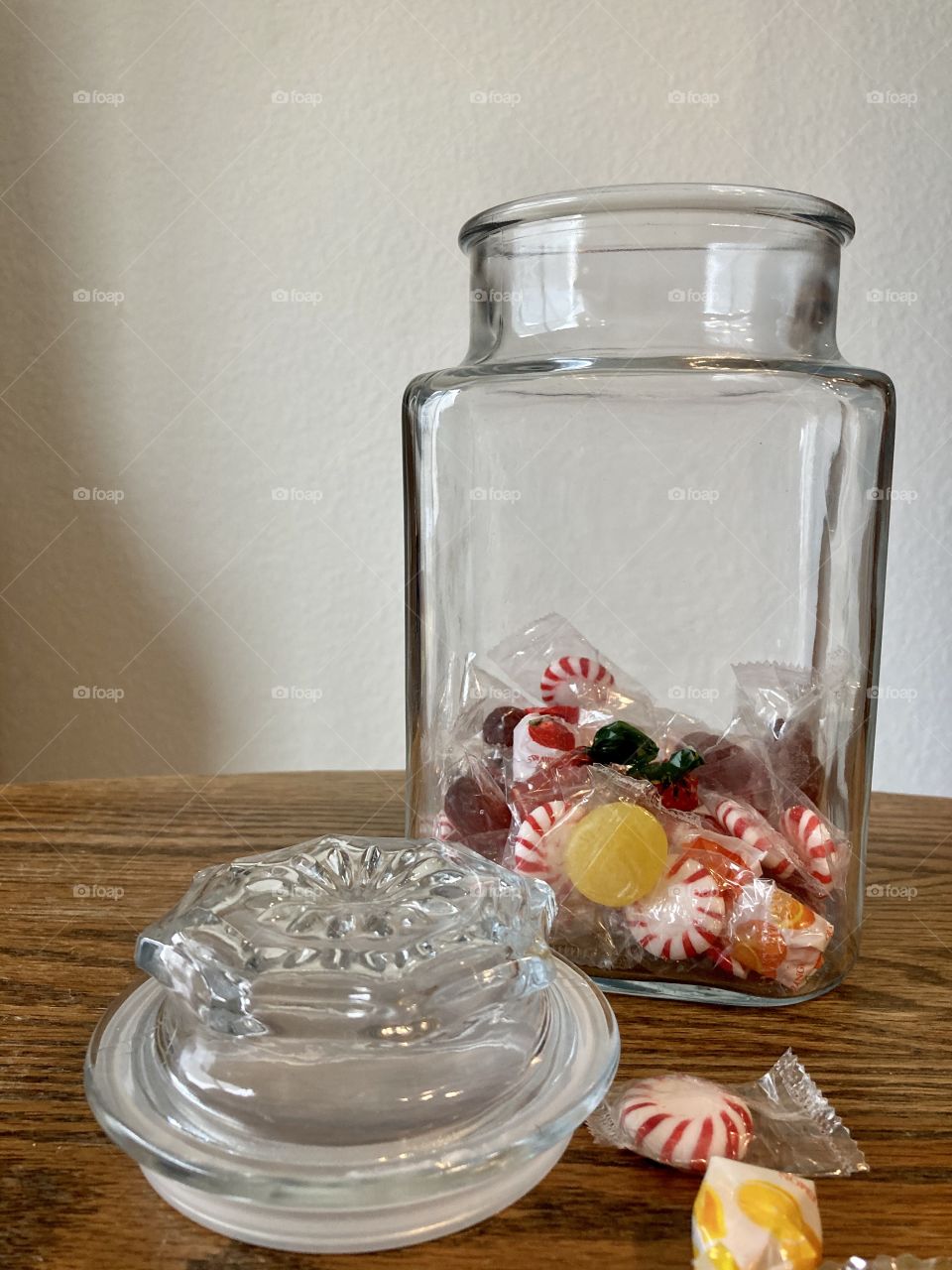 Candy jar with lid on table and hard candy