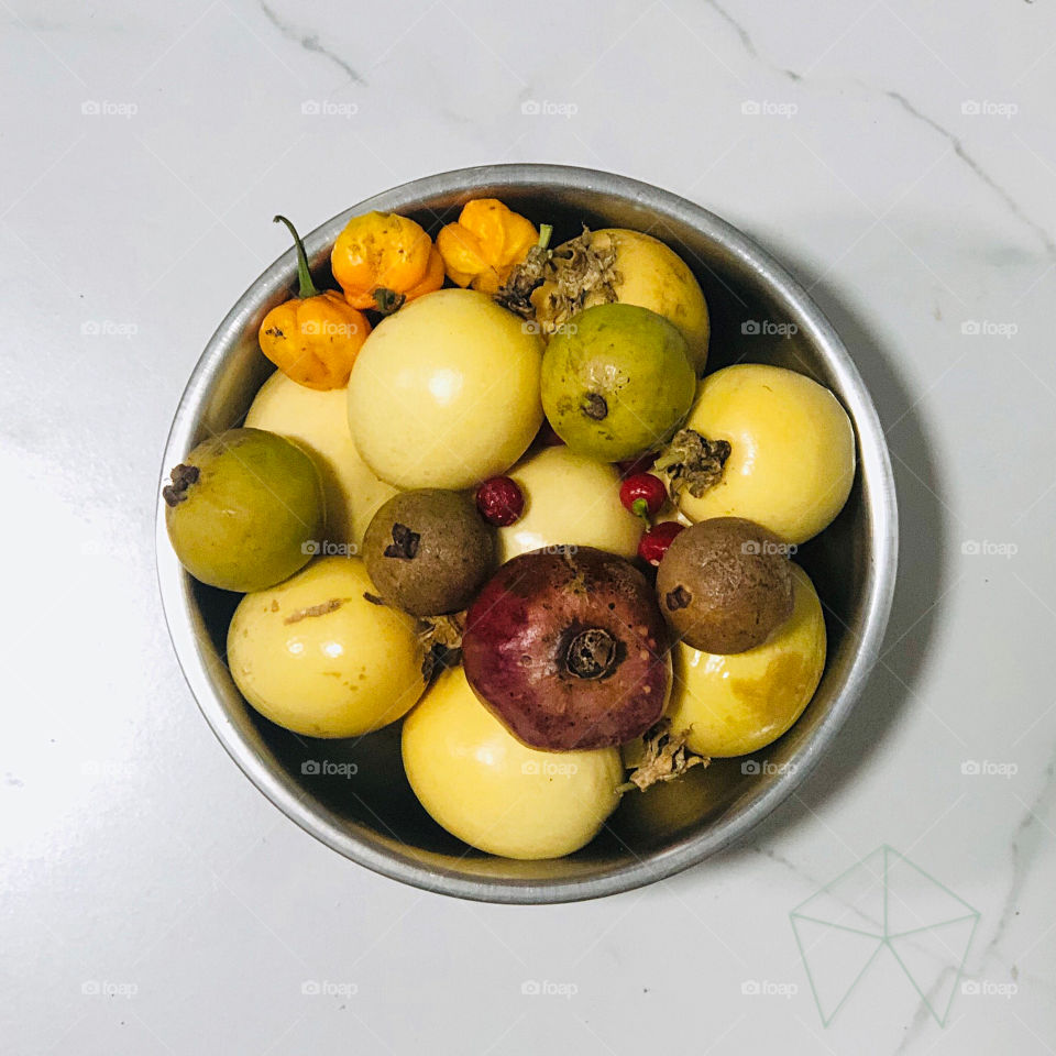 A bowl of home grown fruits and peppers
