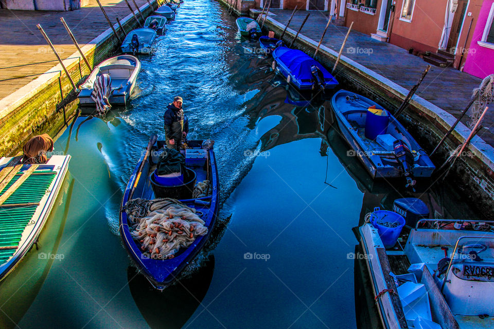 A man in his fishing boat in Venice