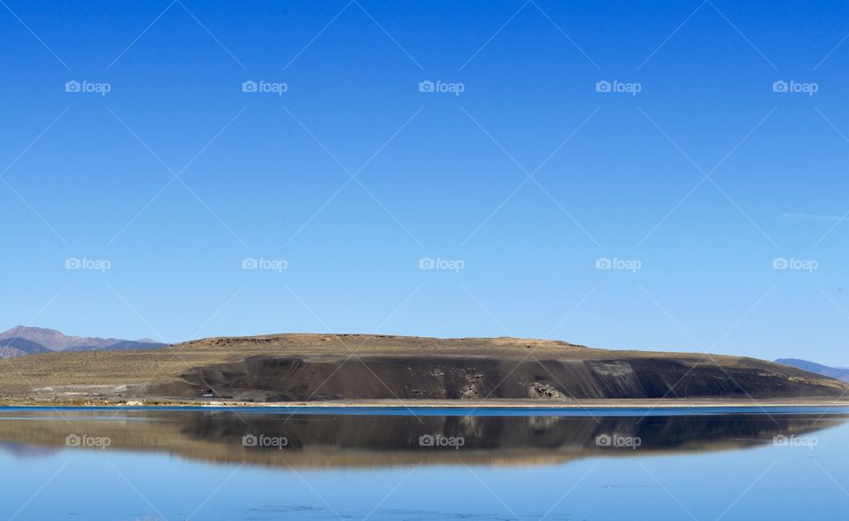 Reflection of high Sierra mountain on lake suitable as background, wallpaper, desktop, plenty of negative space for copy or text or desktop icons 
