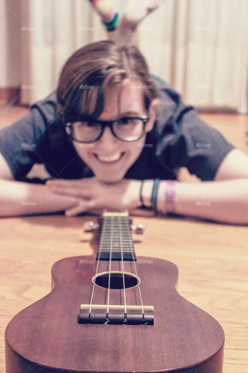 Girl posing beside ukulele 