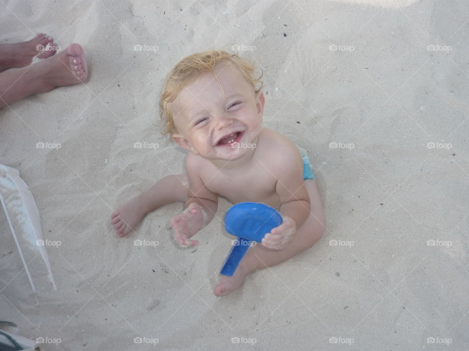 kid playing with sand