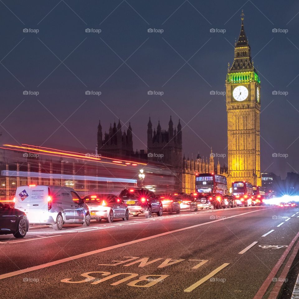 One of London's most famous landmarks, the iconic Elizabeth Tower (commonly known as Big Ben) and the Palace of Westminster illuminated at night with traffic on Westminster Bridge.
