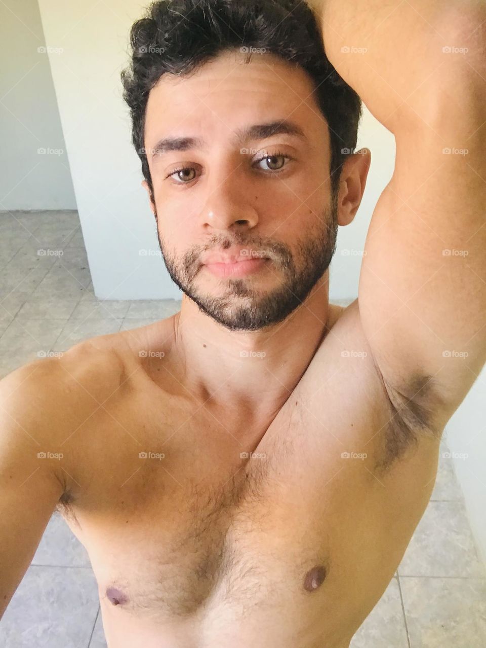 handsome man with beard showing armpit