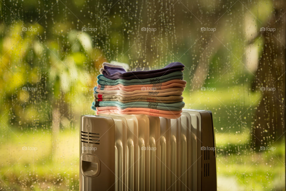 socks on a heater in a rainy day