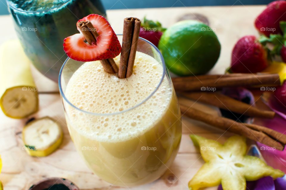 Colorful green and white smoothies on table