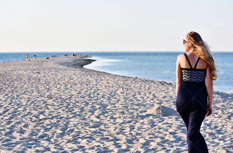 woman walking along the baltic sea in rewa