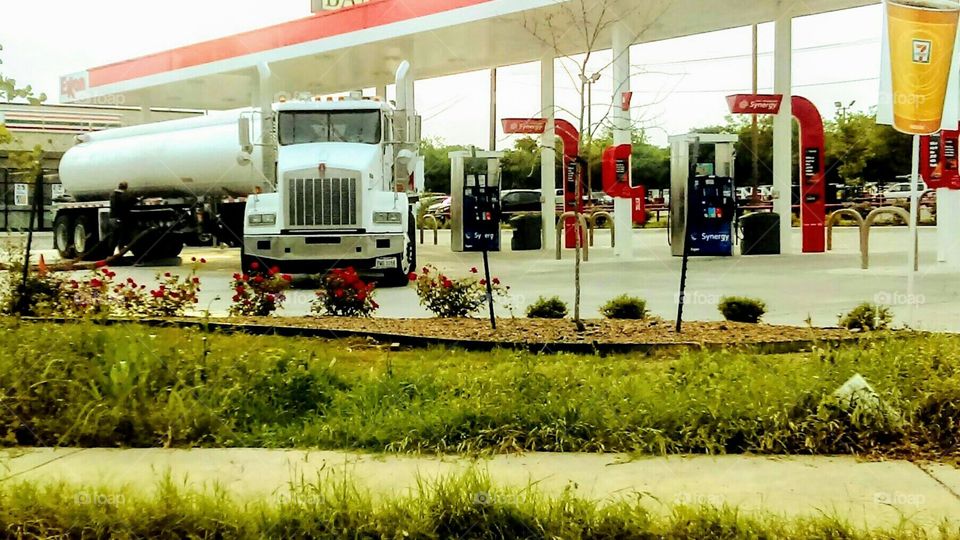 18 wheeler being refueled at the gas station