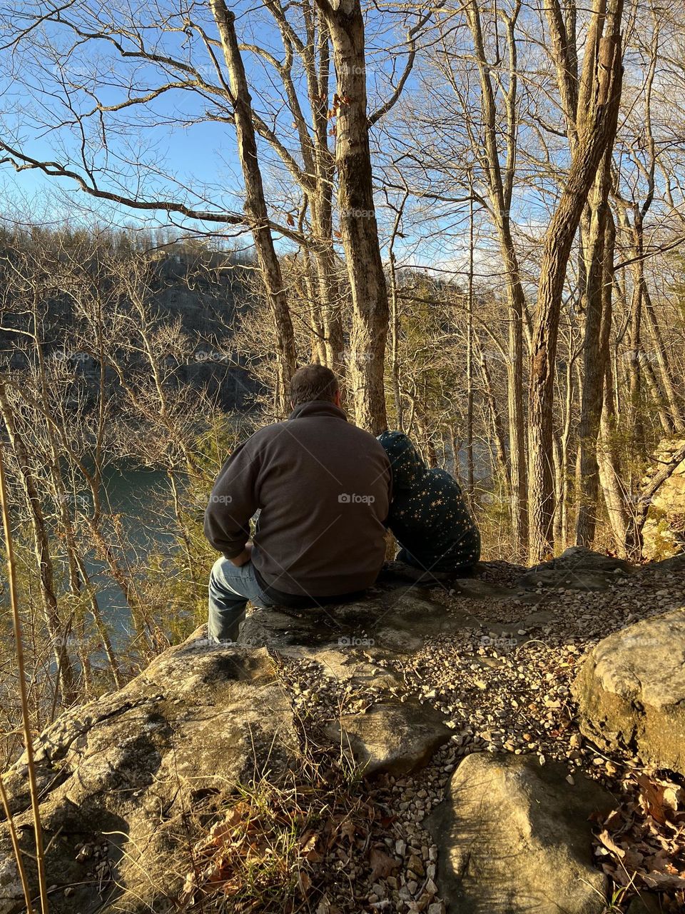 Father and daughter enjoying a peaceful winter day at the lake 