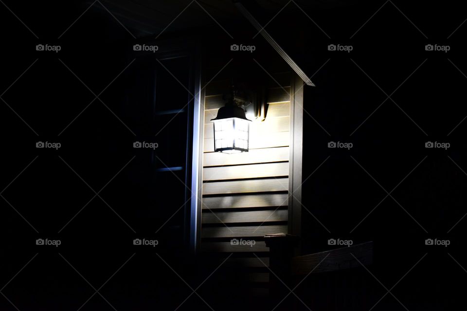 A porch light illuminates the wall