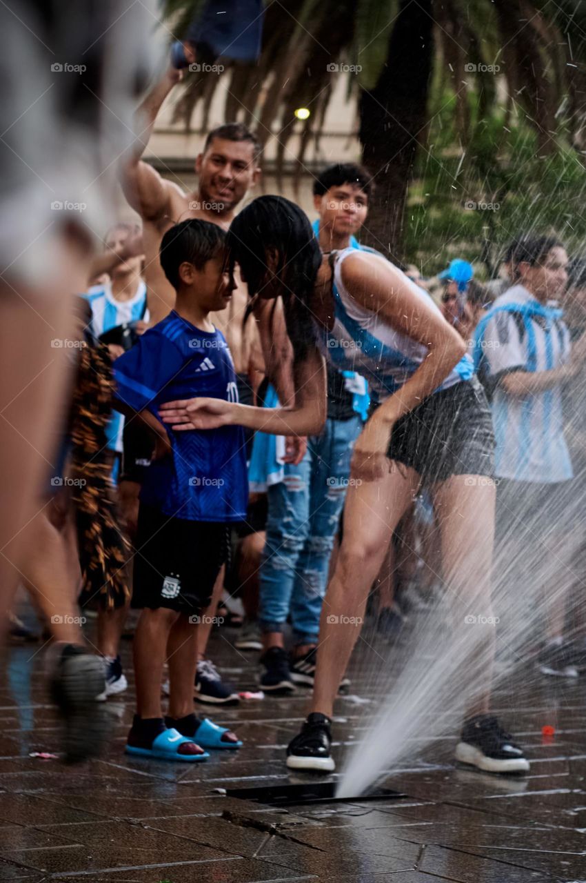 Children playing with water in the street
