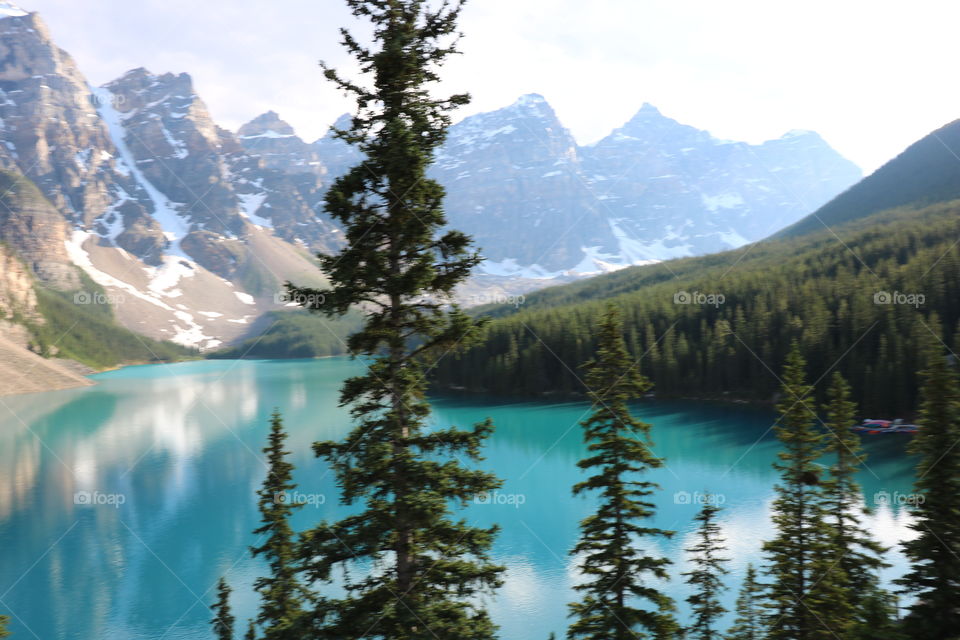 The turquoise lake Luise surrounded with Rocky mountains and woods .. Glaciers from the mountain mirroring into the water making the scenery a natural art. A must see ...