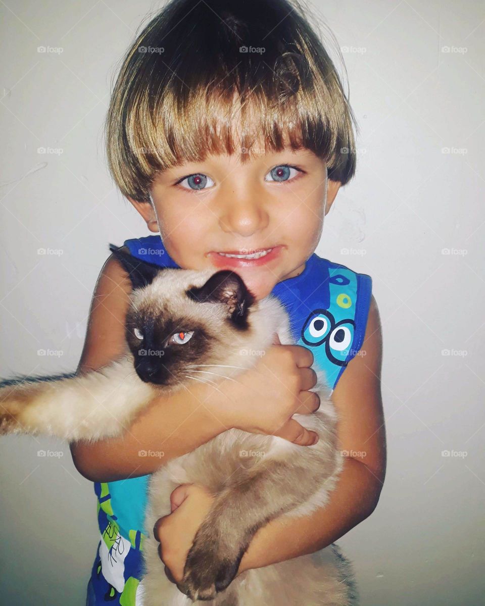 pretty child playing with the kitten