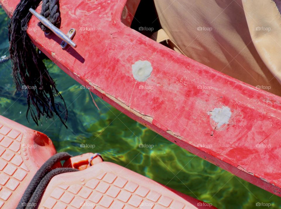 Red boat over green water