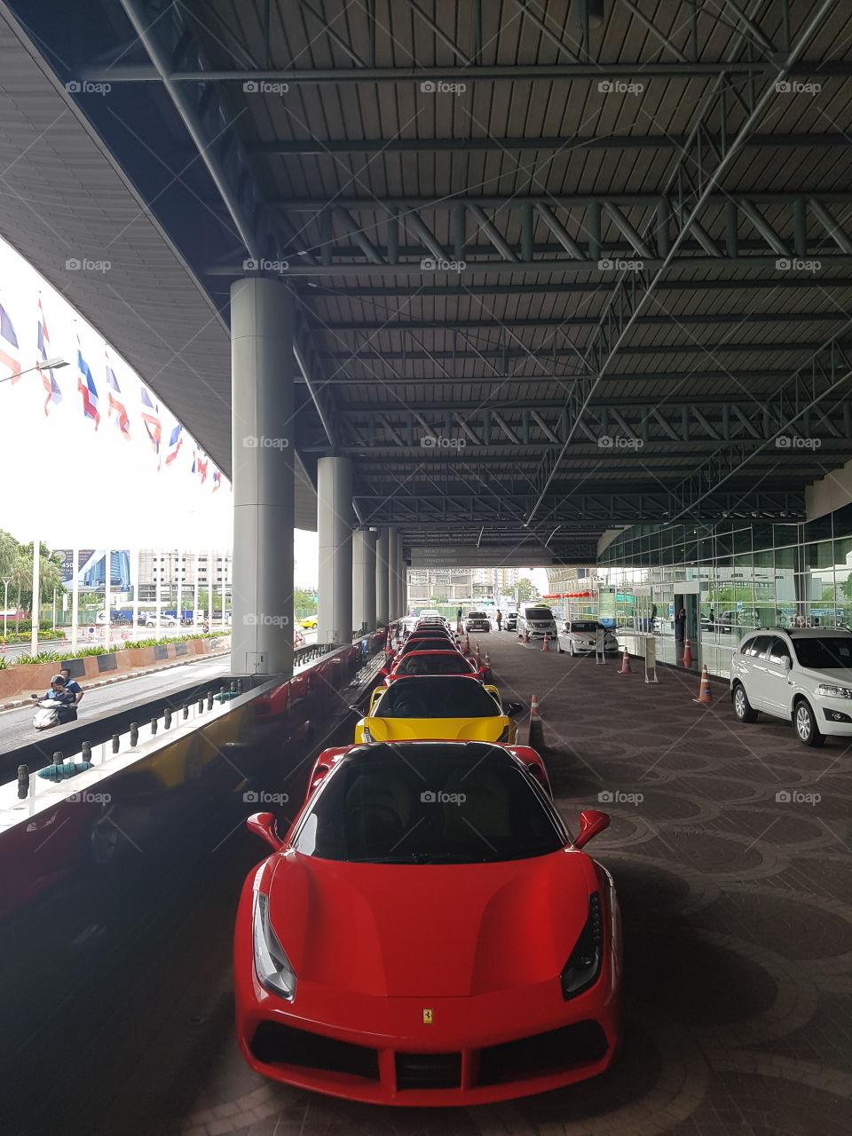 Red Ferrari 488 spider twin-turbocharged V8 luxury sports car parked in line