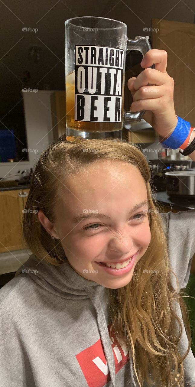 Daughter with a drink on her head 