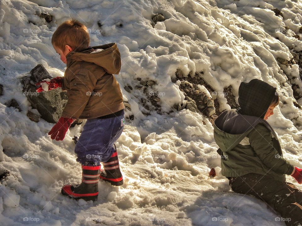 Young Boys Playing In The Snow