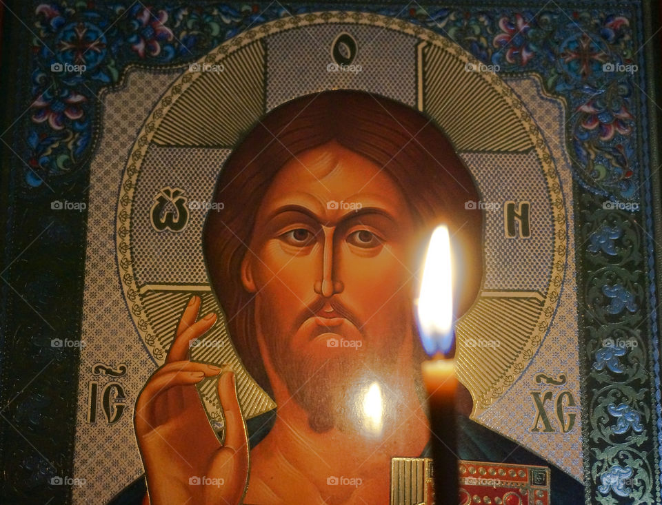 Russian orthodox icon of Jesus and candle in front 