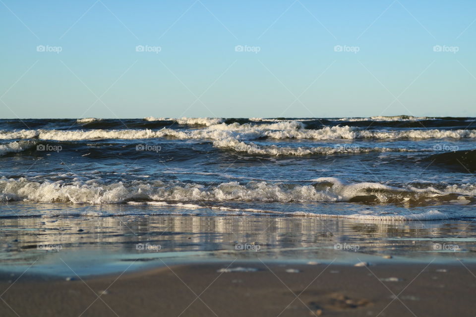 The blue colors of baltic sea at the beach of Karlshagen on the island of Usedom in Germany at summery sunset