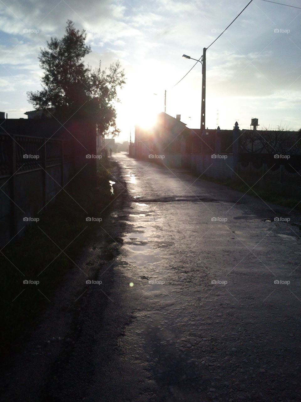 Sun shining over the village on a wet raining winter morning