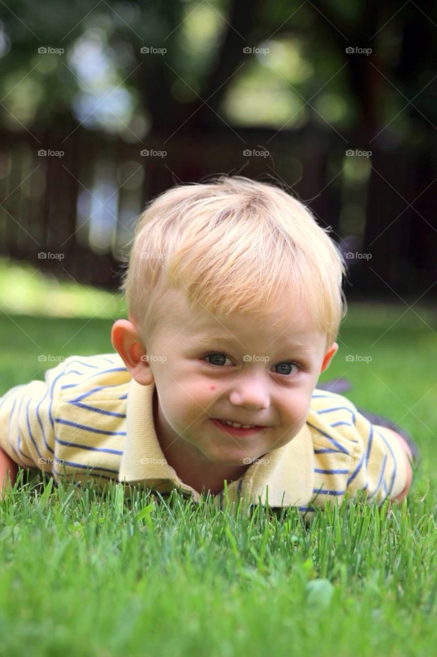 Cute boy lying in grass