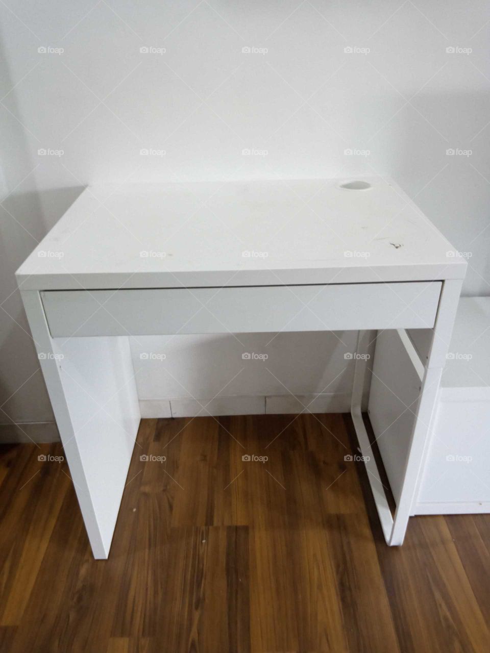 A simple, small working table in white color