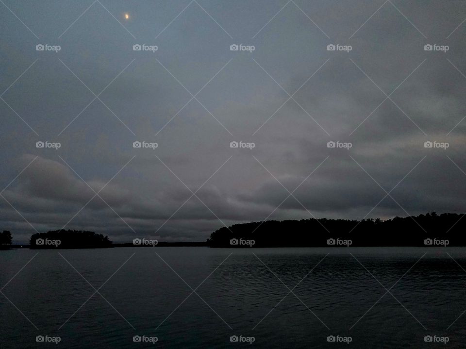 moon shrouded by clouds after a rainy day