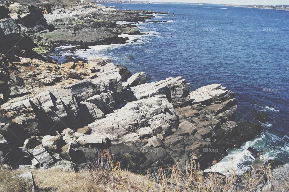 Waves crashing on the cliffs at the Portland Lighthouse