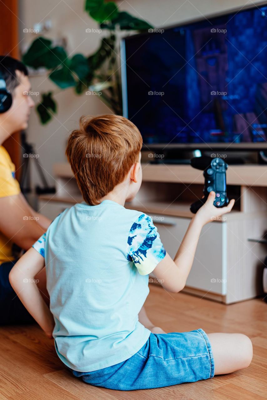 Red-haired boy with his father watches a 3d movie