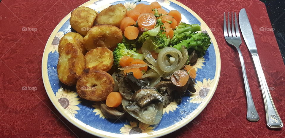 Potatoes vegetables and steak