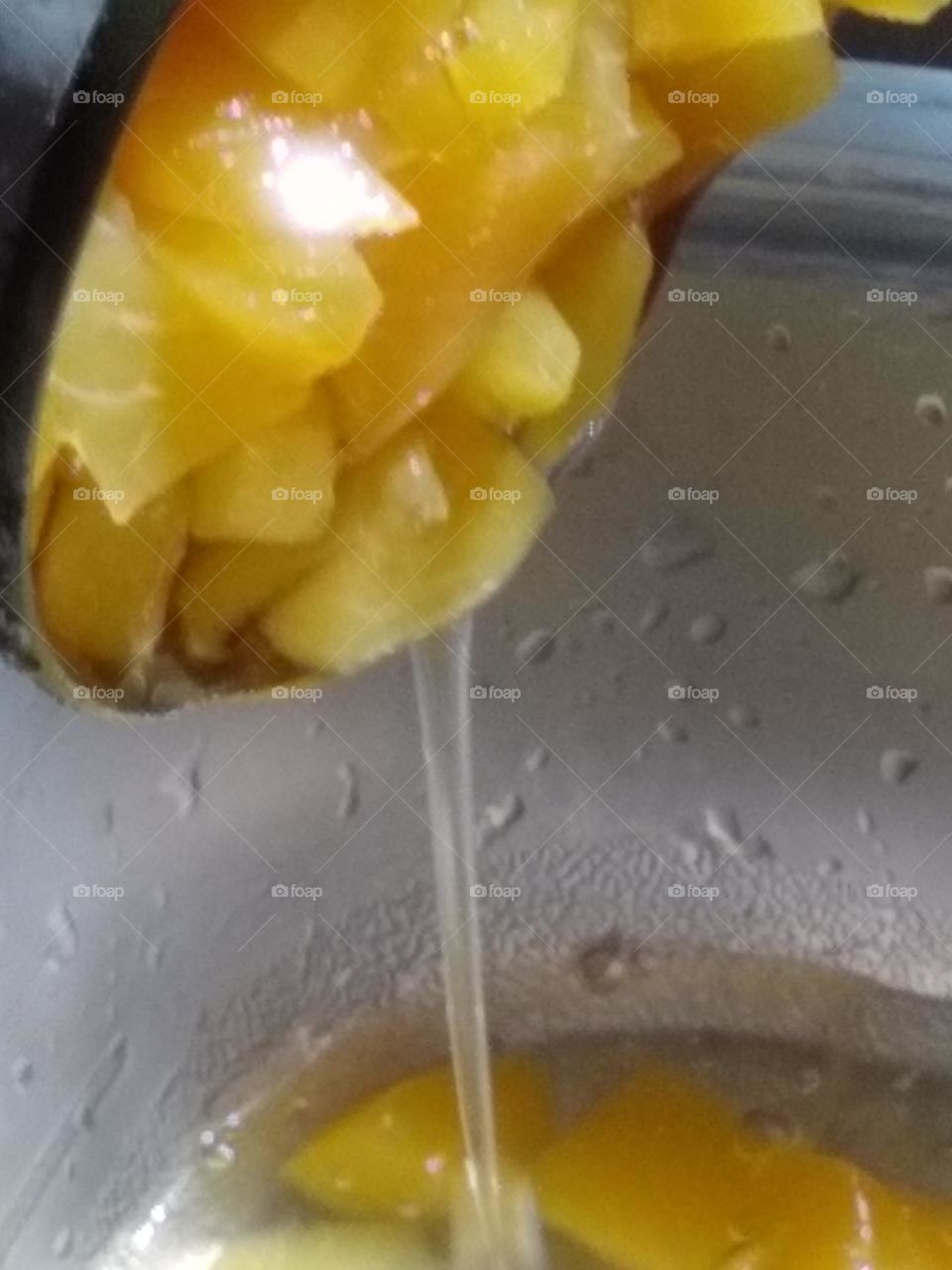 Progressive pictures of the process of pouring peaches 🍑 in bowl.