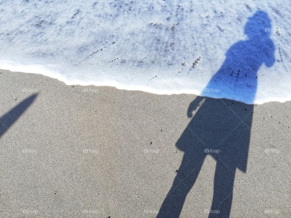 Shadow of a woman on the beach