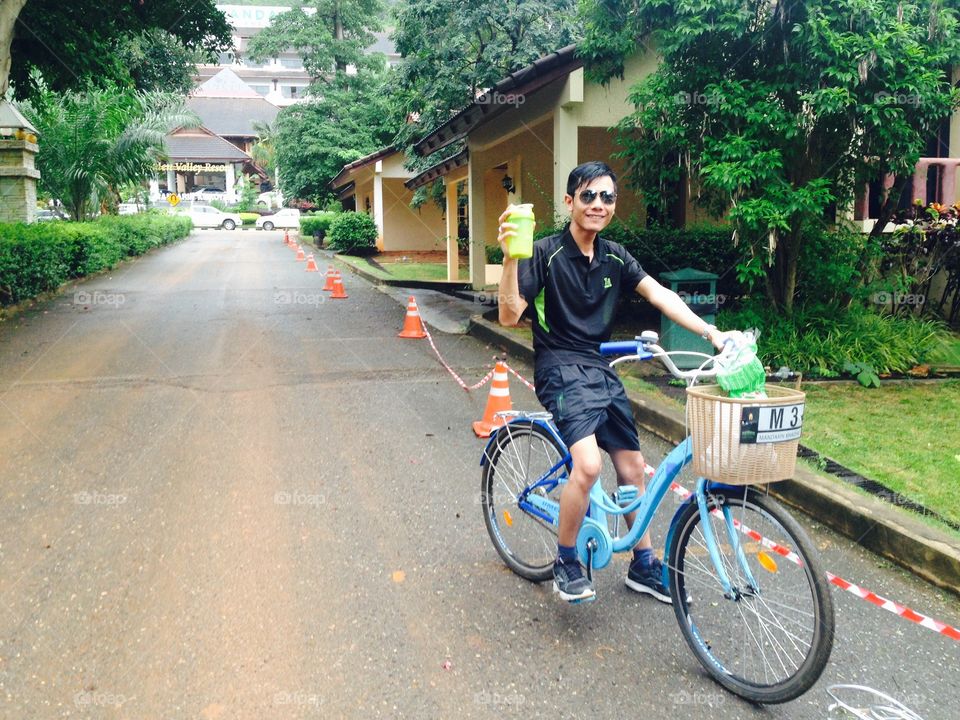 A man cycling a morning exercise bike in Khao Yai, Thailand.