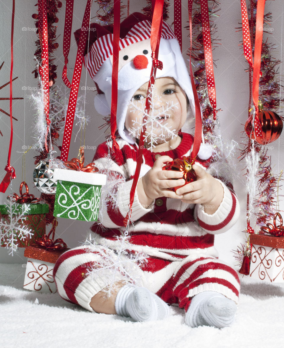 Close-up of baby boy with chirstmas decoration