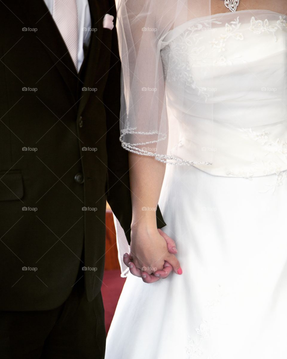 Bride and groom holding hands