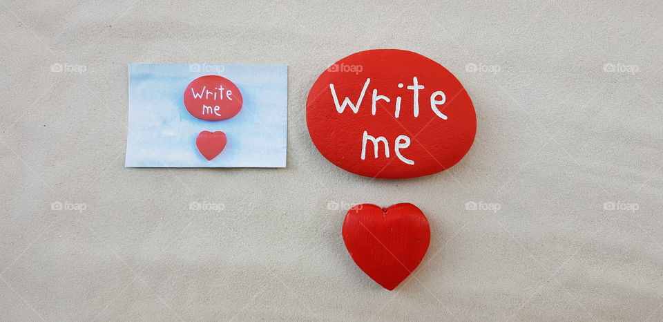 Write me, creative message with a creative picture, a wooden red heart and a red stone