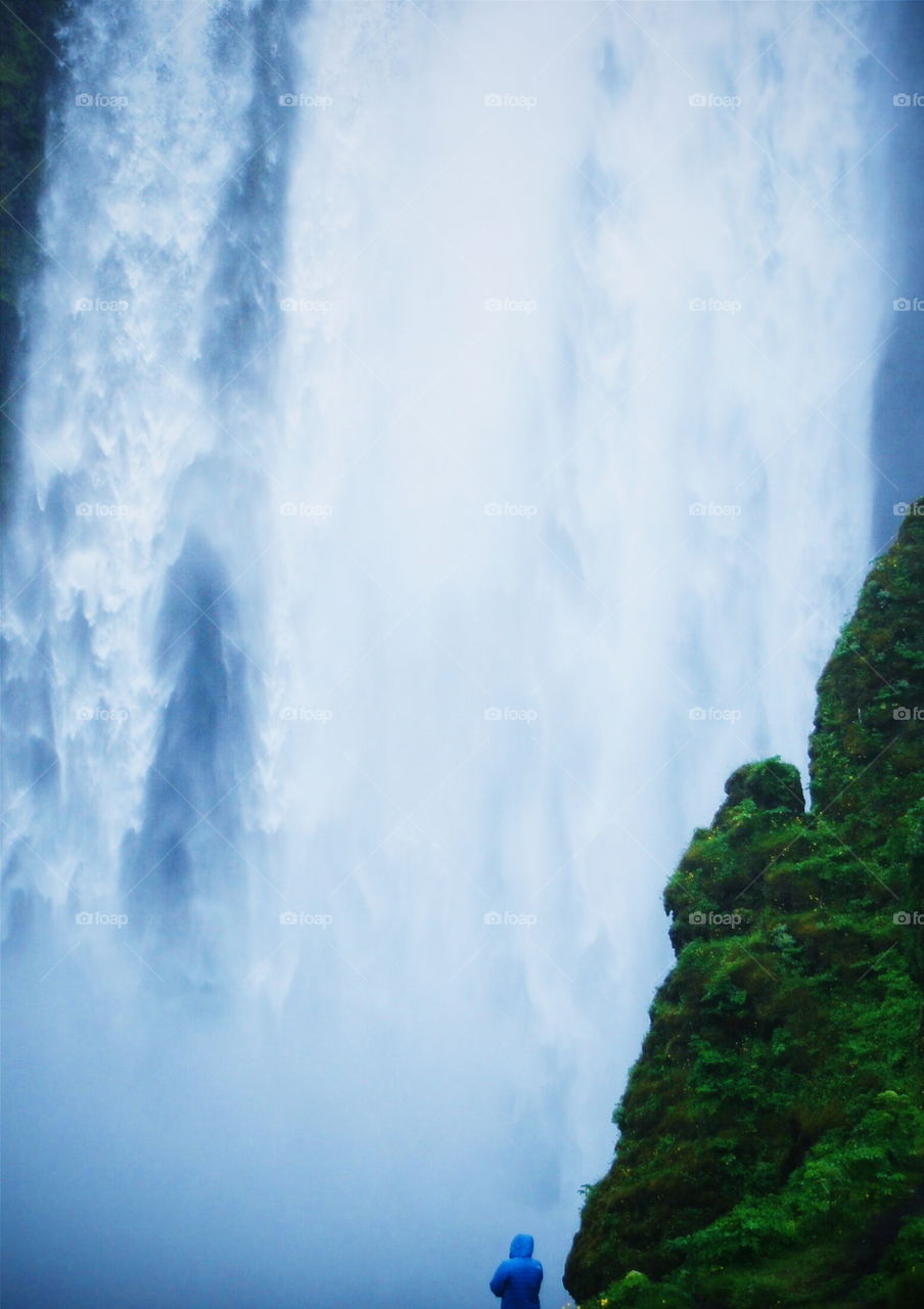 Tourists looking at view of waterfall