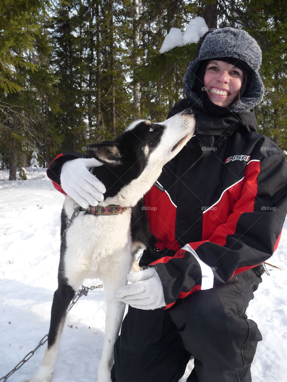 Portrait of woman with her dog in snowy weather