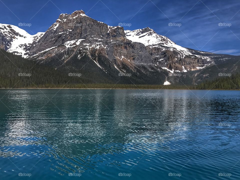 Emerald Lake, British Columbia, Canada. A beautiful Mountain with snow on a warm summer day. 