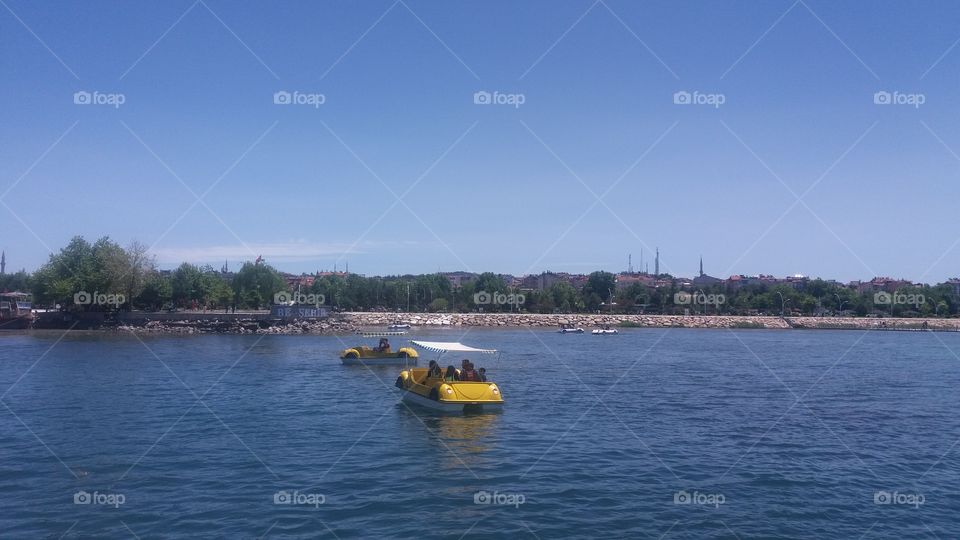 yellow catamaran and blue lake