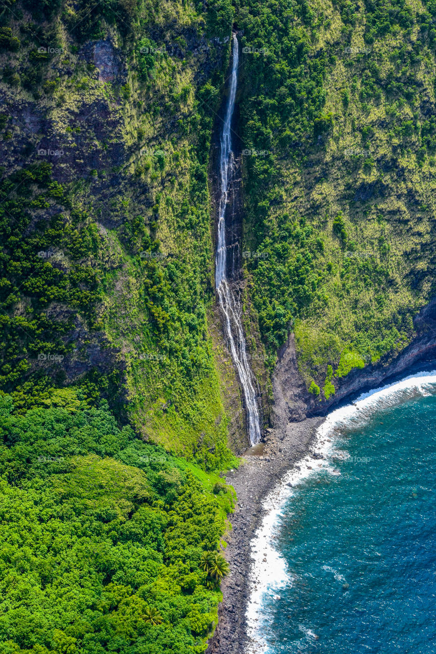 Waterfall and coast in Big island Hawaii