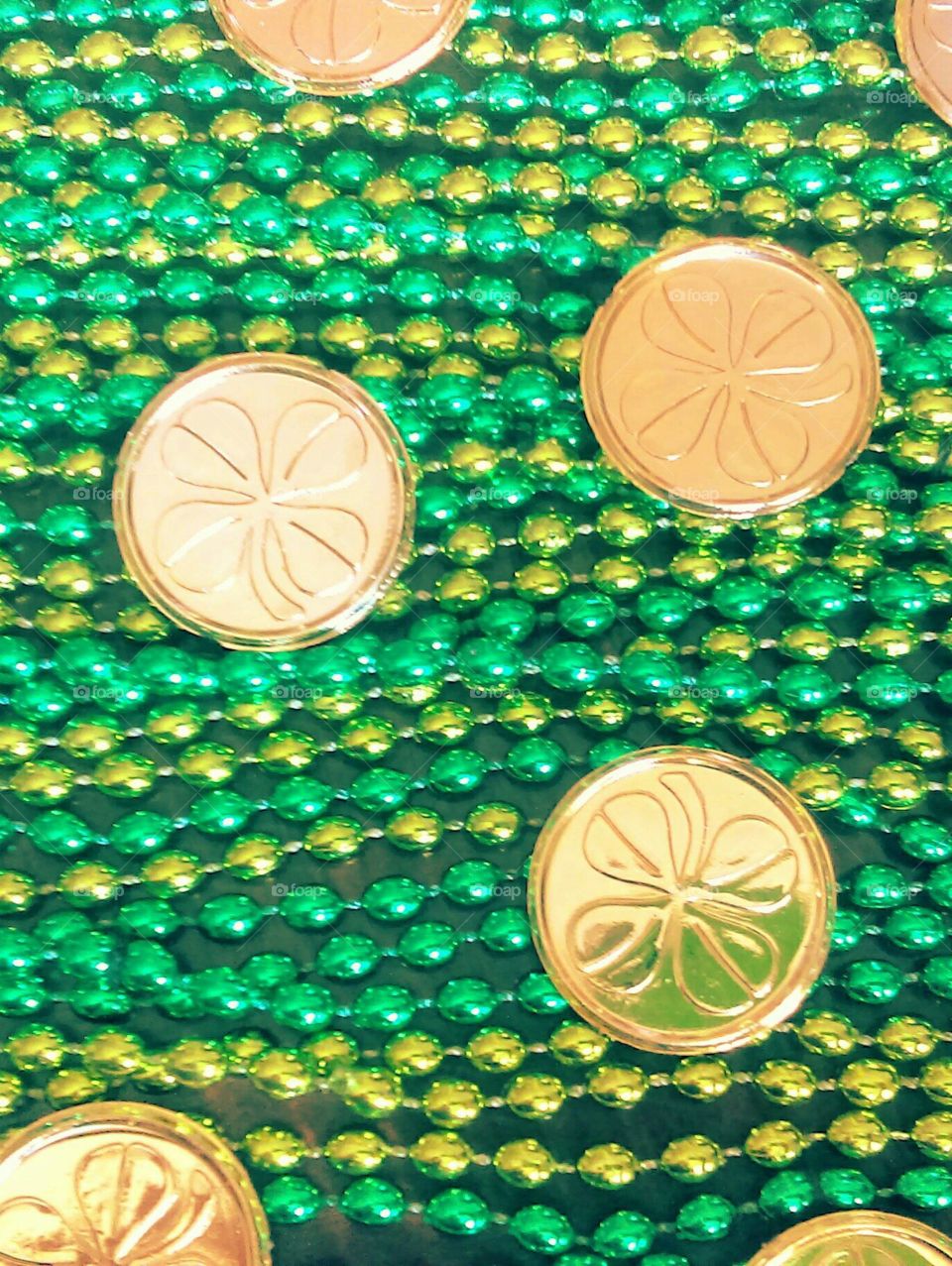 Gold leaf clover coins with green beads.