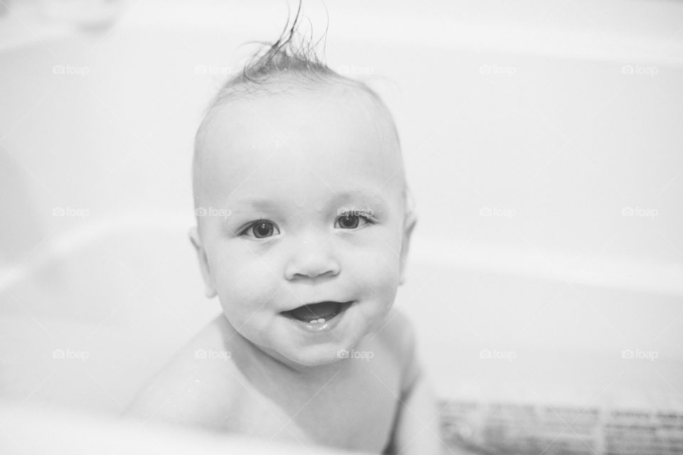 Toddler boy in tub wet hair 