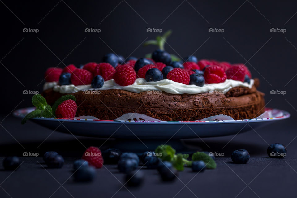 Berry cake against black background