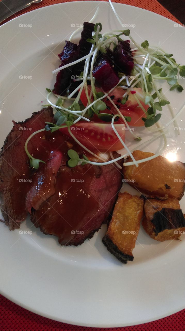 Roasted beef with pumpkin and vegetables salad.