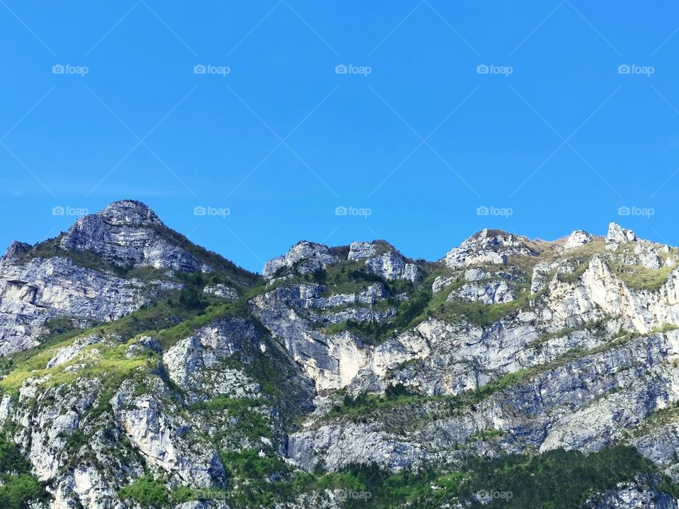 Rock stone mountain against blue sky in Italy. Copy space.