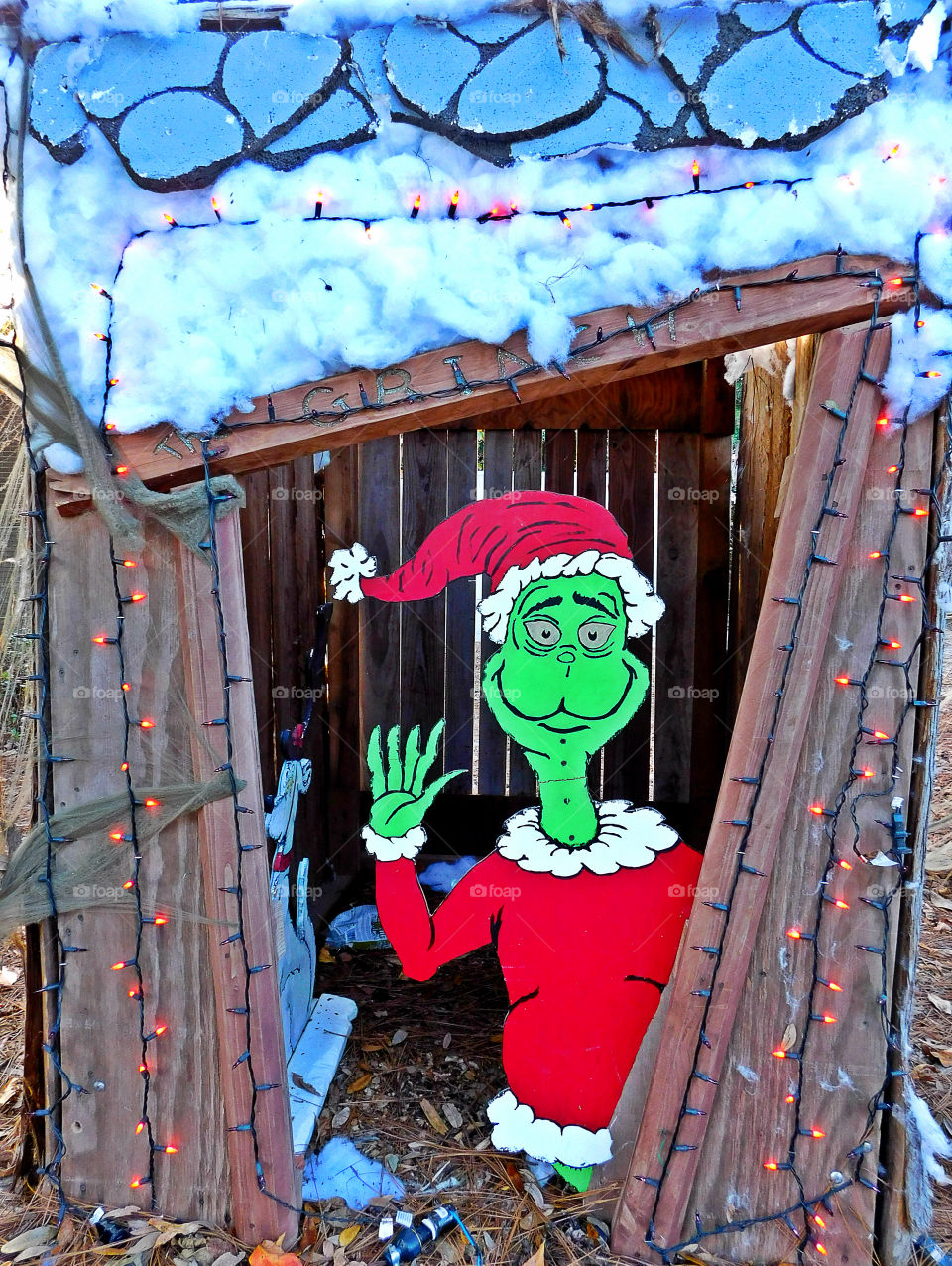 Happy Grinch!
Grinch waving from the shed decorated by Christmas lights!