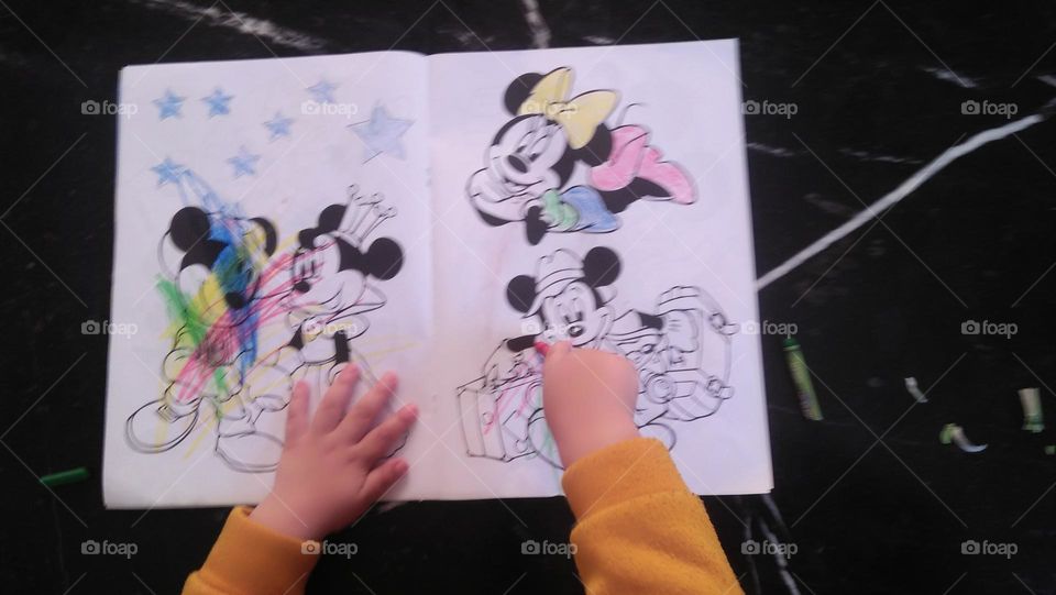  A young child colors pictures