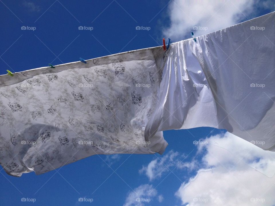 Sheets on clothesline blowing in the wind