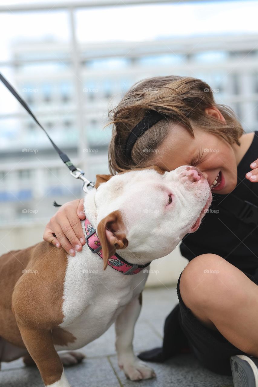 walking the dog down the street, the owner walks the weakling, teaches her, cleans up after her, educates, plays with his pet. people and dogs are best friends